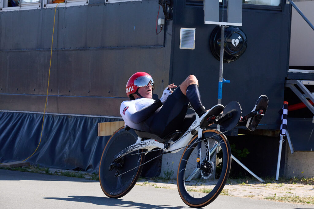 Un atleta con casco rosso pedala su una bicicletta reclinata a due ruote al Tom Dumoulin Bike Park